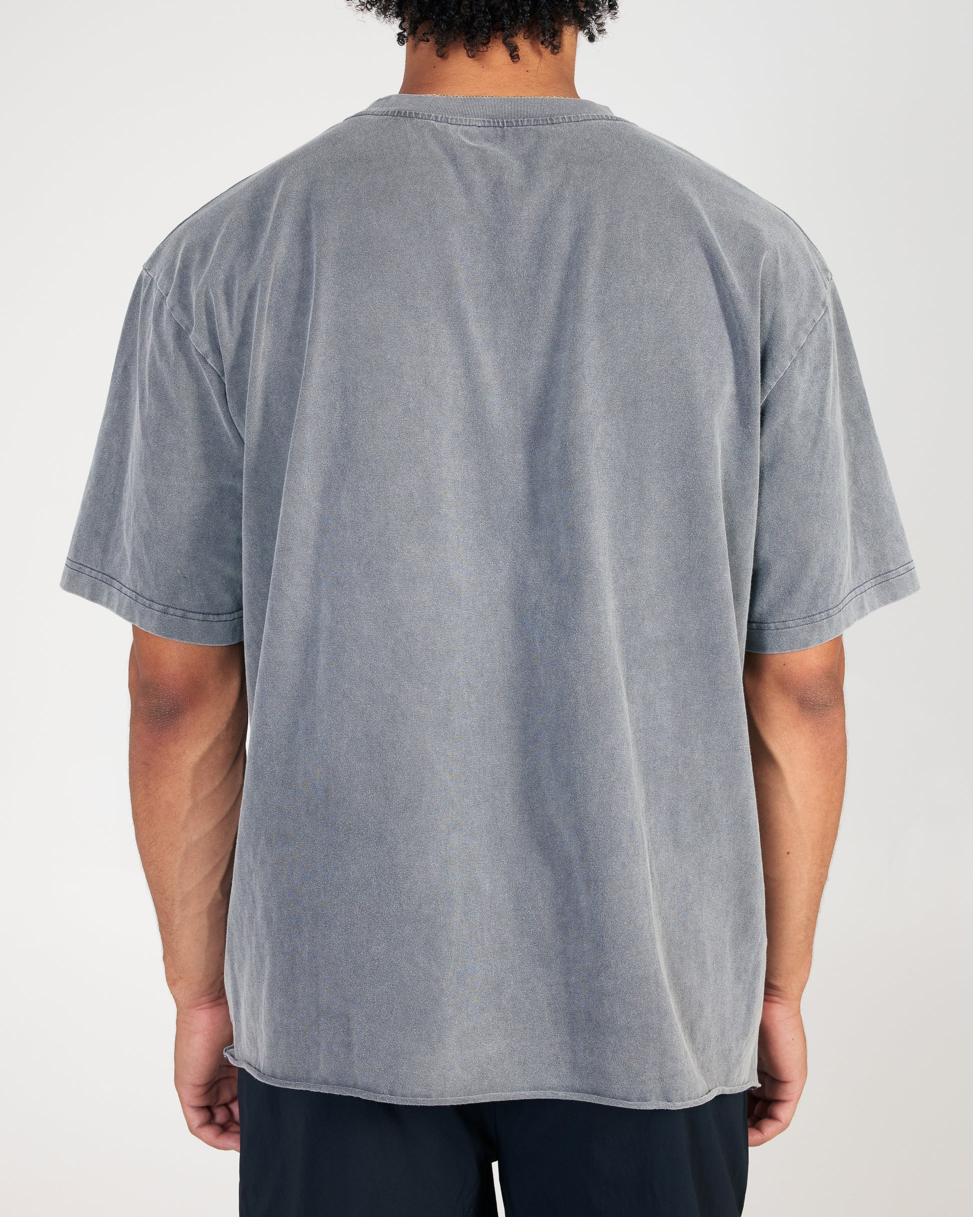 Person wearing a gray t-shirt on a white background