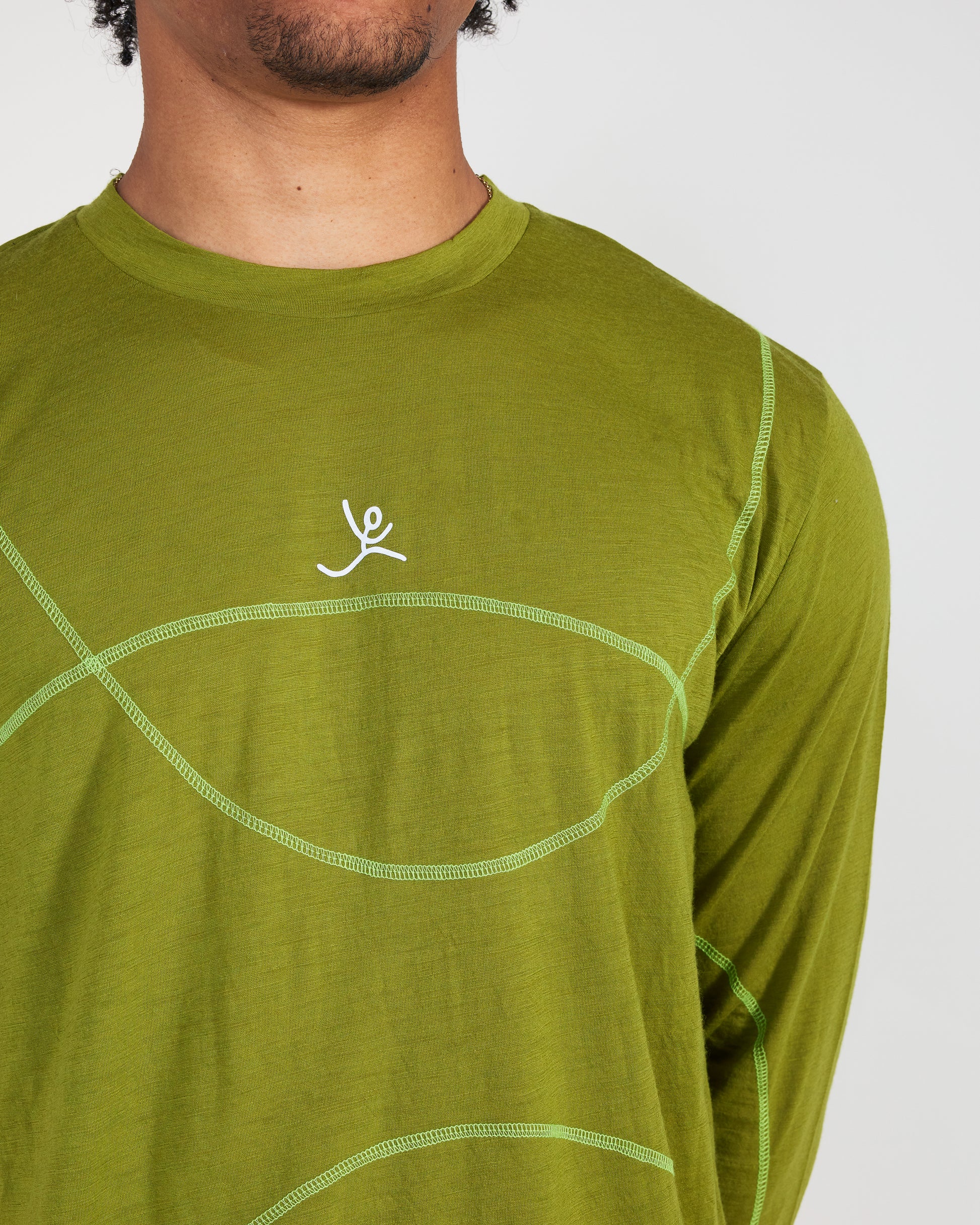 Green long-sleeve shirt with a logo on a plain background