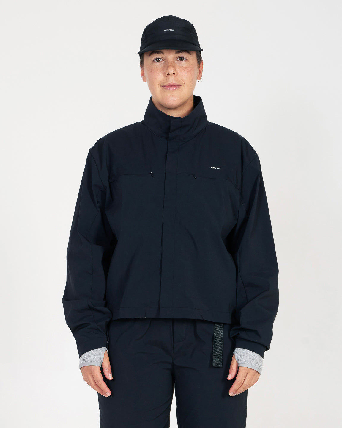 Person wearing a black jacket and pants on a white background