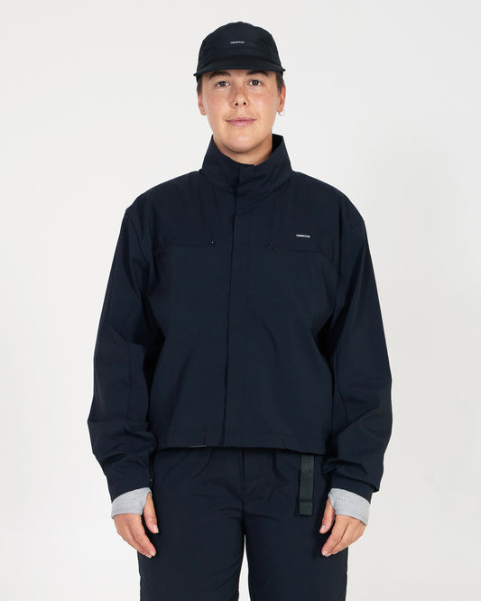 Person wearing a black jacket and pants on a white background