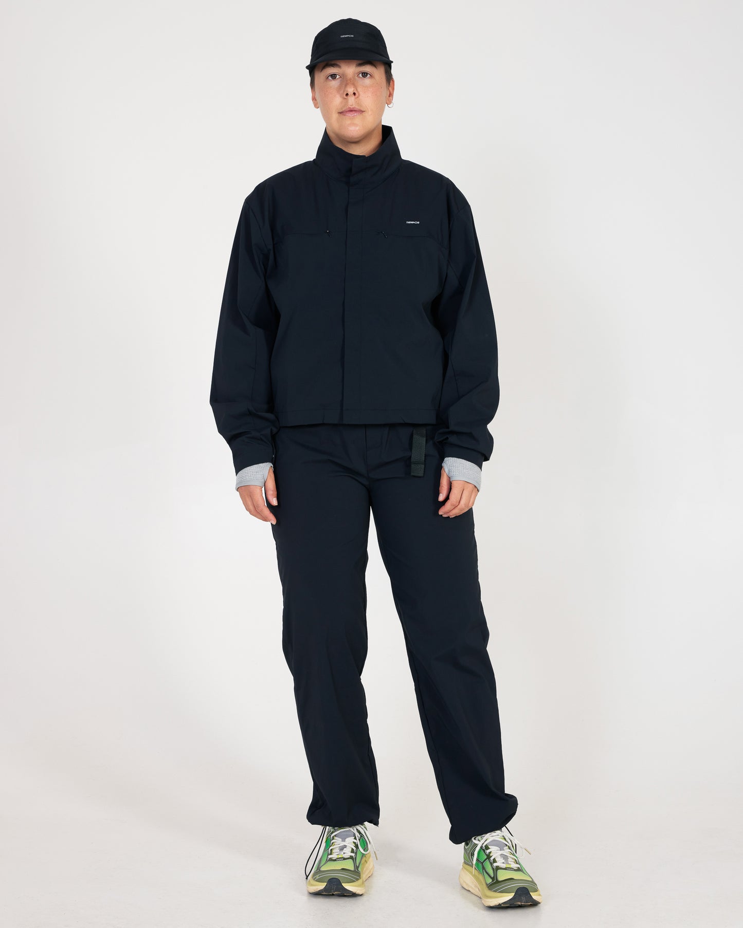 Person wearing a black outfit with a white background