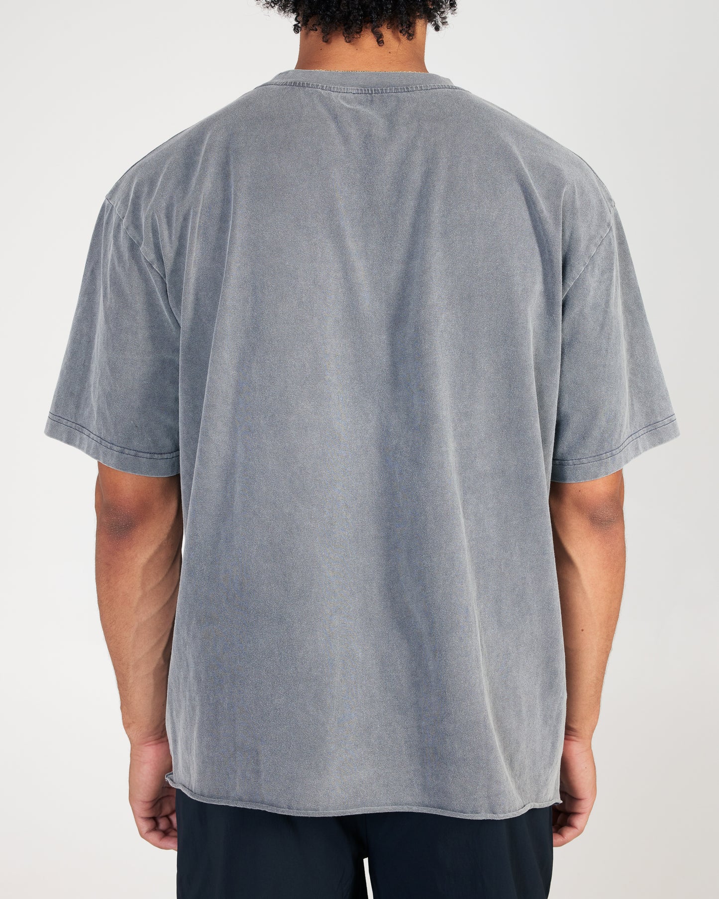 Person wearing a gray t-shirt on a white background