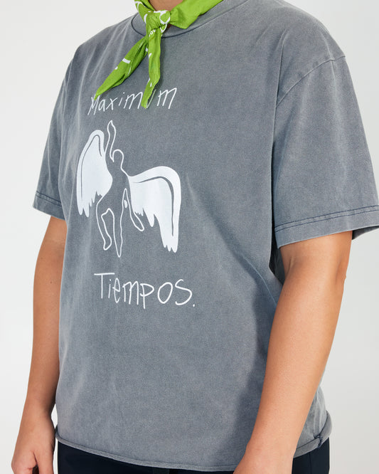 Person wearing a gray t-shirt with white graphic and text, green bandana, on a plain background