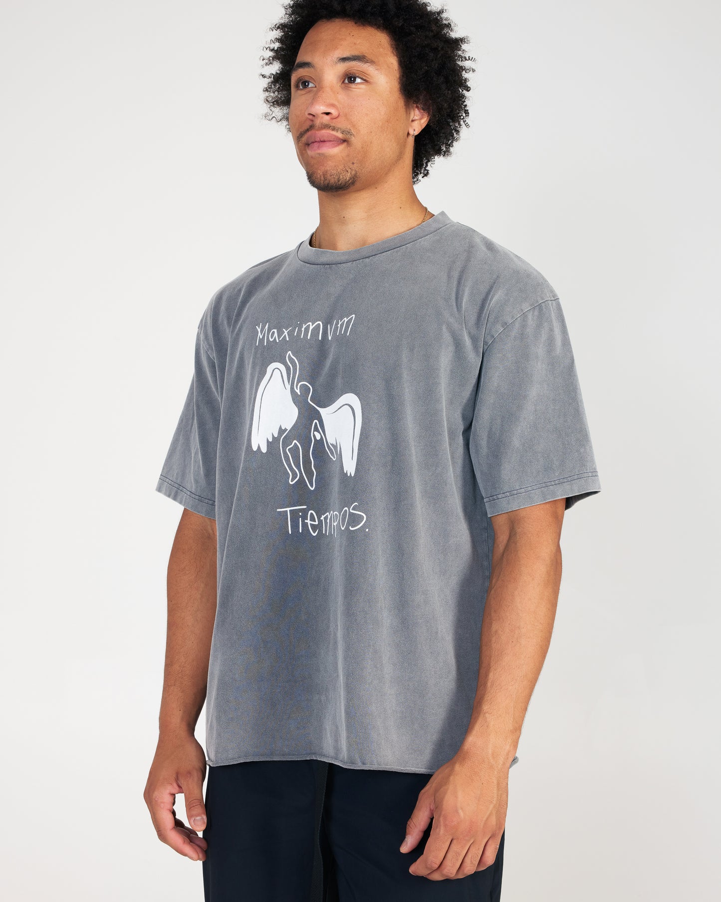 Man wearing a gray t-shirt with graphic design and text on a plain background