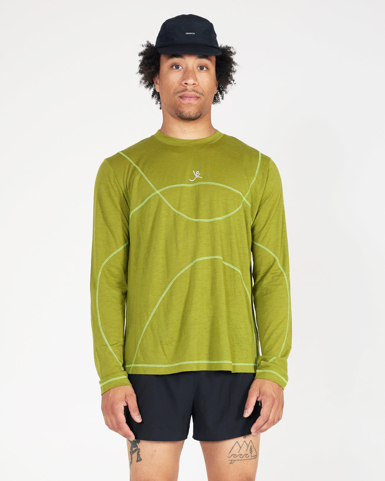 Man wearing a green long-sleeve shirt with a logo on a white background