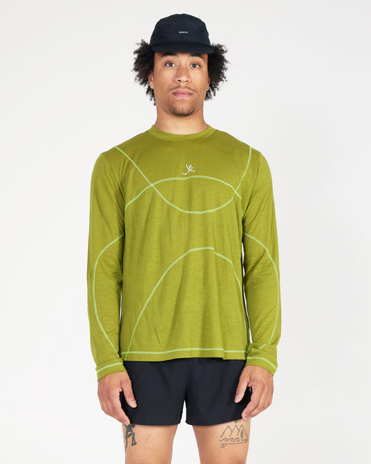 Man wearing a green long-sleeve shirt with a logo on a white background