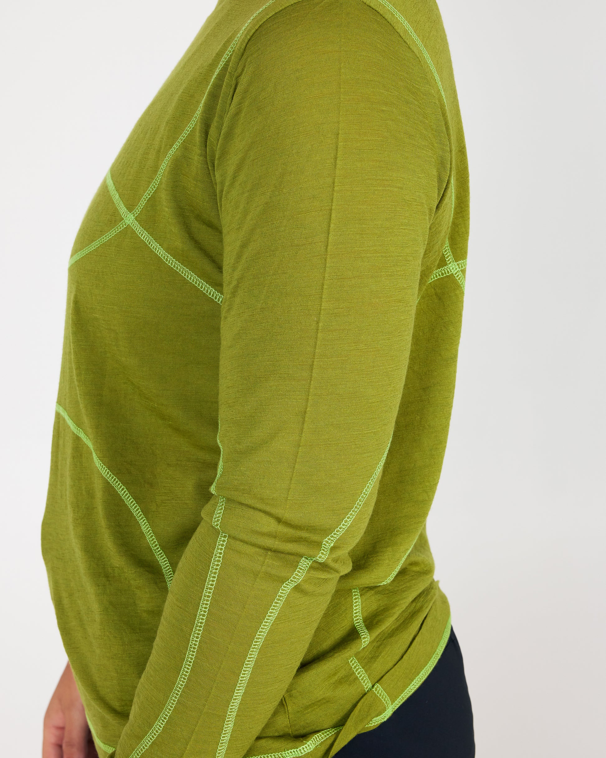Green long-sleeve shirt with white stitching on a white background
