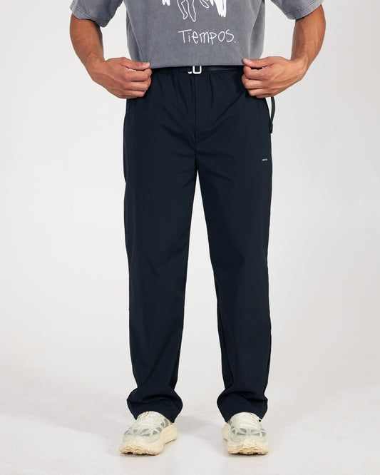 Person wearing black pants and a gray shirt with text on a white background